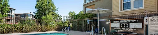 Apartments in Walnut Creek, CA- Ivy Hill- Sparkling Pool and Spa with Blue Lounge Chairs and View of Apartment Complex