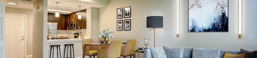Apartments in Walnut Creek - Ivy Hill - An interior shot of the living room connected to the kitchen with carpeting on floors