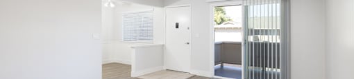 A room with a white wall and a wooden floor.