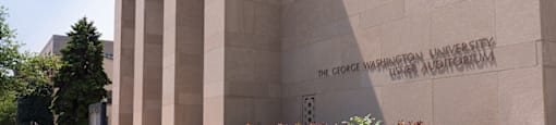 The George Washington University auditorium is a large, beige building with a modern design.  at The 925 Apartments, Washington, DC
