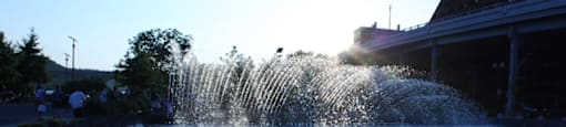 A water fountain is shooting water into the air in a plaza.  at The 925 Apartments, Washington, DC