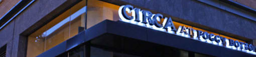 A storefront with a circular logo above the entrance.  at The 925 Apartments, Washington, DC