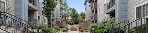 a view of a pathway between two apartment buildings