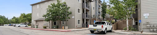 a white truck parked in front of an apartment building