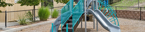 a playground with a slide in a park