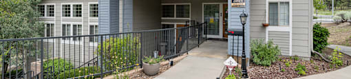 a house with a porch and a sidewalk in front of it
