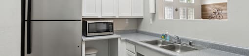 a kitchen with stainless steel appliances and white cabinets