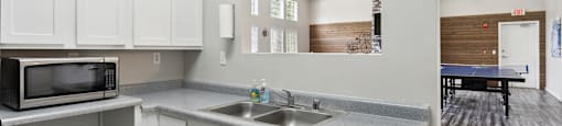 a kitchen with a sink and a microwave