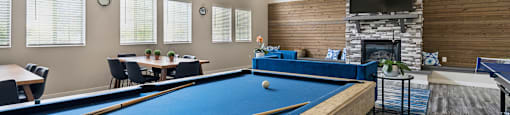 a games room with a pool table and a fireplace