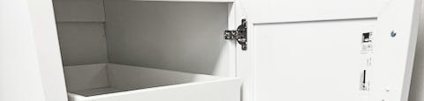 A white kitchen pantry with an open door.