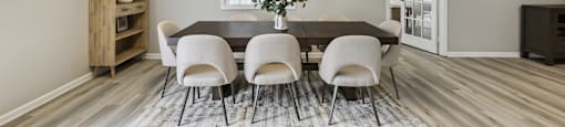 an image of a dining room with a table and chairs