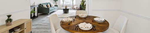 a living room and dining room with a table and chairs