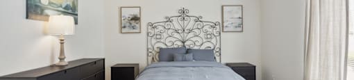 a bedroom with a bed and a dresser and a window