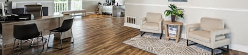 A room with wooden floors and a large painting on the wall.