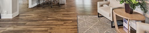 the living room and dining room of a home with wood floors and white walls