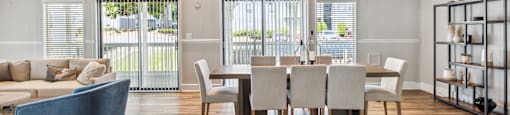 a living room and dining room with a table and chairs