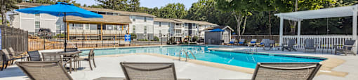our apartments have a swimming pool with chairs and umbrellas