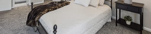 a bedroom with a bed and a ceiling fan