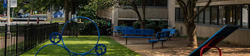 a park with a playground and a tree
