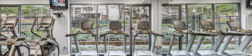 a gym with treadmills and other exercise equipment