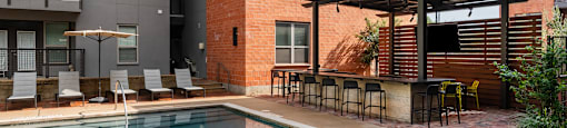 Swimming pool at The Can Plant Residences at Pearl, San Antonio, TX 78215 next to a building