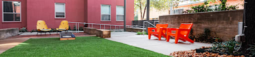 Outdoor Yard with a ping pong table and grass at The Can Plant Residences at Pearl, San Antonio, TX 78215and a white counter top  at The Can Plant Residences at Pearl, San Antonio, 78215