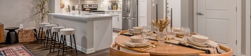 an open kitchen and dining room with a table and chairs at The Can Plant Residences at Pearl, San Antonio, Texas