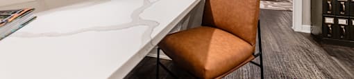 an office with a desk and a chair in a room with a bedroom at The Can Plant Residences at Pearl, San Antonio, TX
