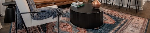 a living room with a couch and a table at The Can Plant Residences at Pearl, San Antonio, TX, 78215