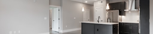 A spacious kitchen with a ceiling fan and a countertop.