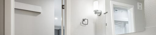 A bathroom with a white sink and cabinets.