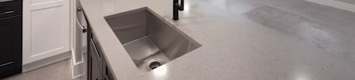 A kitchen with a sink and a ceiling fan.
