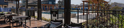 a patio with chairs and tables and a swimming pool