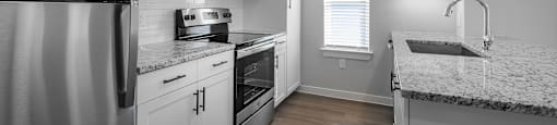a kitchen with stainless steel appliances and granite counter tops
