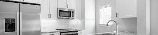 a kitchen with granite counter tops and stainless steel appliances