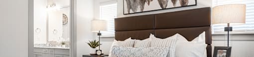 a bedroom with a bed and a dresser and a mirror