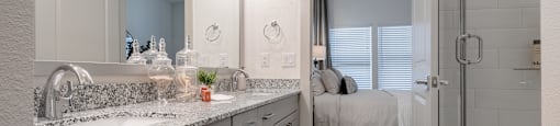 a bathroom with a sink and a shower and a mirror