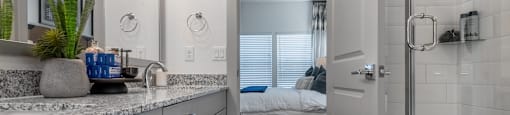 an open bathroom with a shower and a bedroom in the background