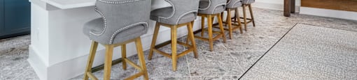 a kitchen with a long counter and bar chairs