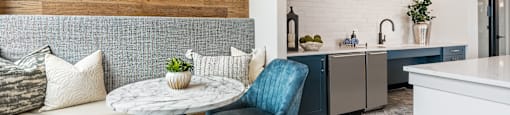 a living room with a couch and chairs and a table