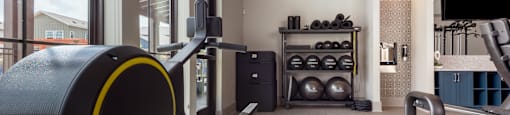 a gym with exercise equipment and a large window