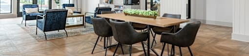 a dining room with a wooden table and chairs