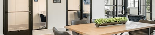 a dining room with a table and chairs and glass doors
