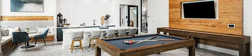 a game room with a pool table and a tv