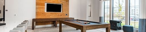 a game room with a pool table and a television