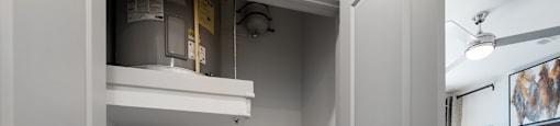 a white washer and dryer in a room next to a bedroom
