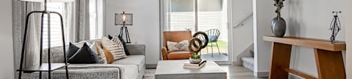 a living room with a gray couch and a coffee table