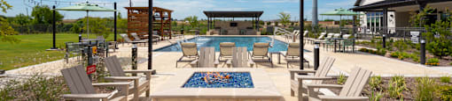 A pool area with chairs and a pool table.