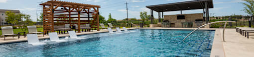 A large swimming pool with a wooden structure and lounge chairs.