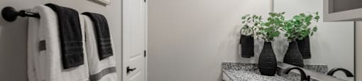 A bathroom with a white counter top and a mirror above it.